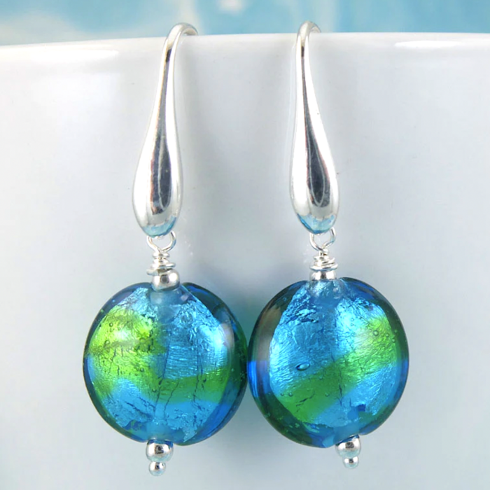 Hand-blown glass earrings by Sailorgirl Jewelry with blue and green foil inside the glass.